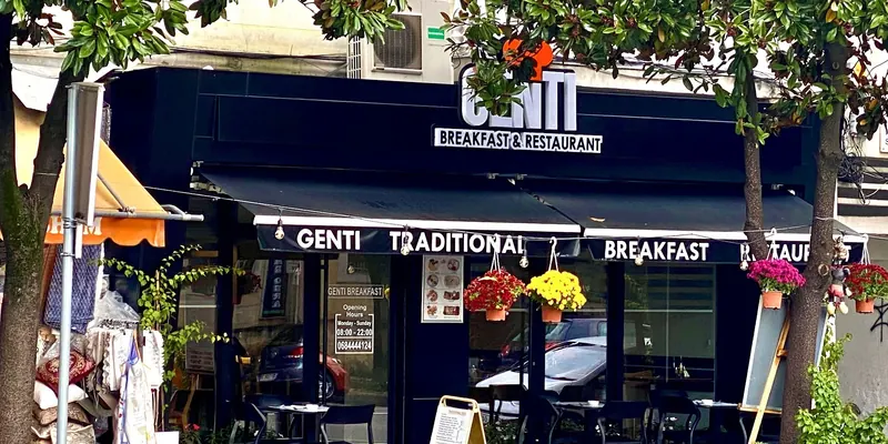 The Genti storefront on Bulevardi Skënderbeu, with tables under the black awning