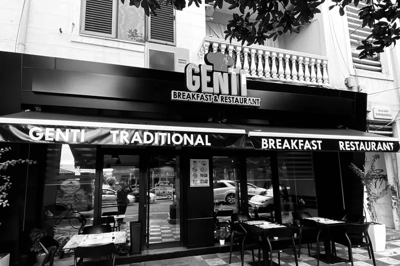 Black-and-white photo of the Genti storefront, with the awning reading Genti Traditional Breakfast Restaurant
